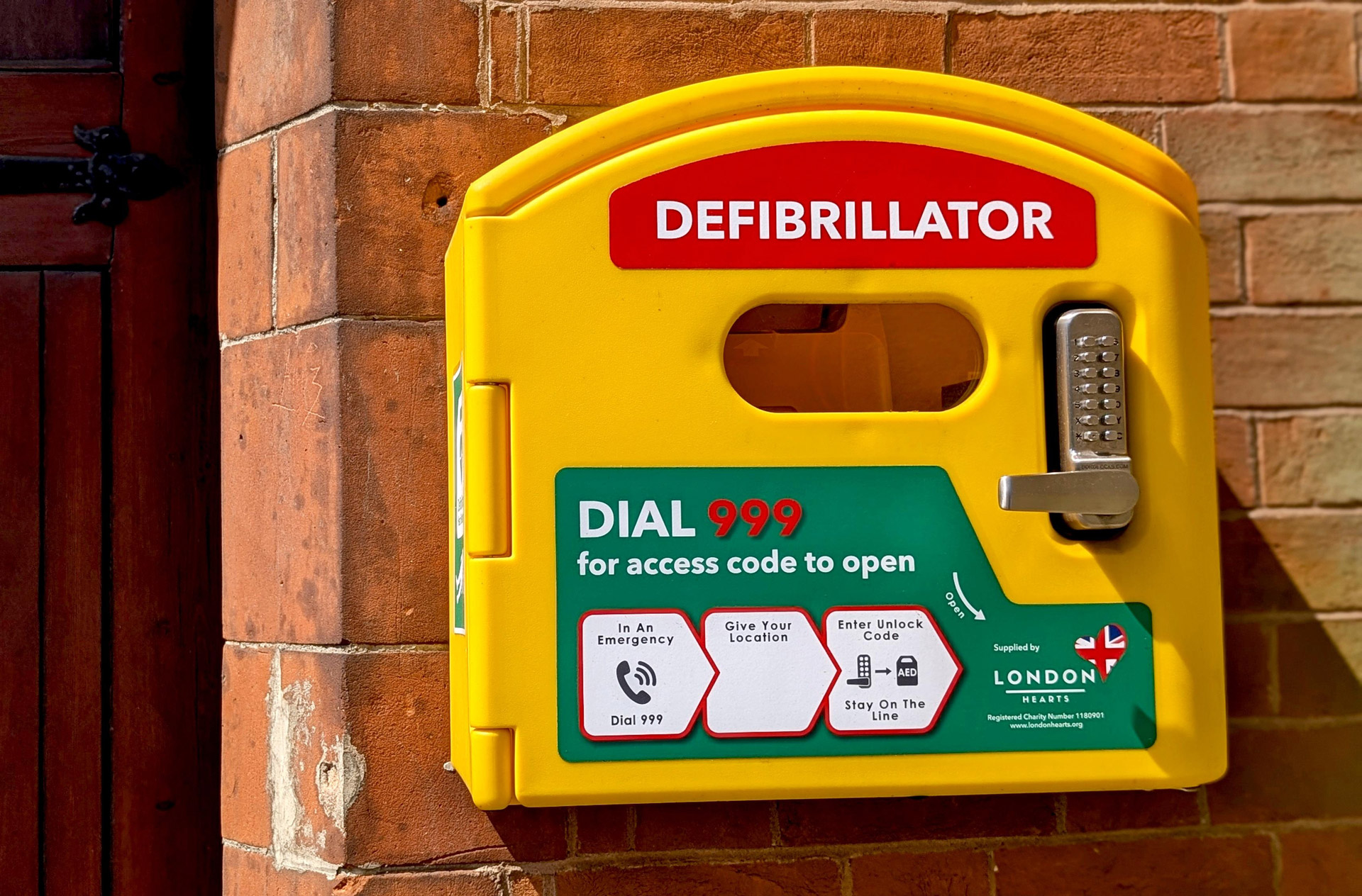 Bright yellow defibrillator on wall