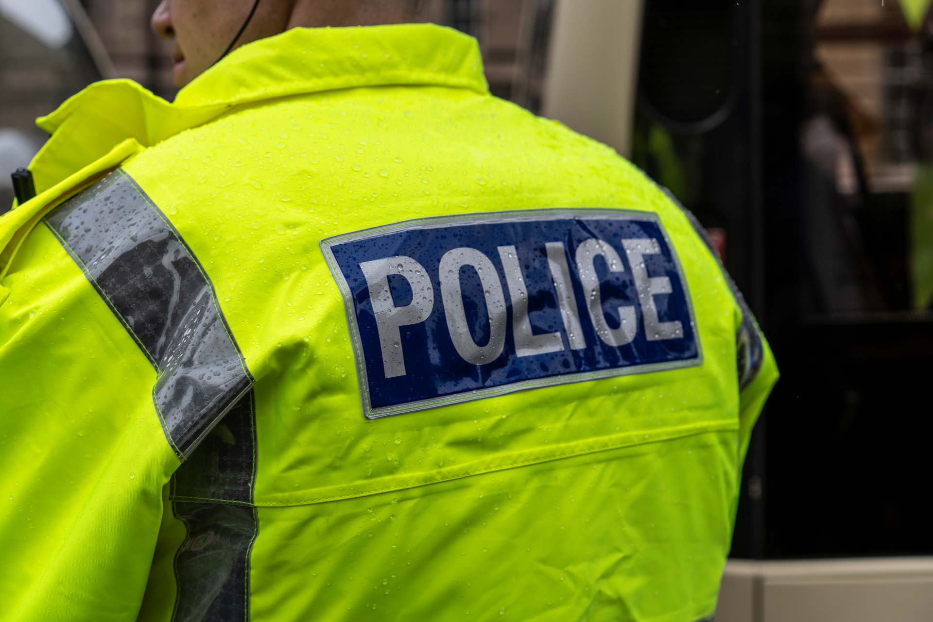 the back of a police officer in Hi vis jacket